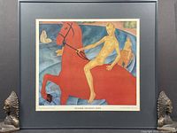Framed print of a nude male riding a large red horse, with second rider in background, mat board framing.