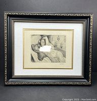 Frontal view of the framed reclining nude print with black and gold ornate frame.