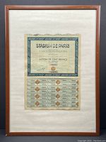 Full view of the framed Stadium de Paris 100 Francs share bond, showing the entire certificate and coupons attached beneath.