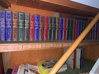 Shelf with multiple colorful hardcover volumes of "The Great Events" and related historical series with gold embossed titles.