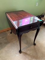 Gibbard mahogany drop leaf side table angled view showing drawer and one leaf down.