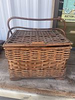 Front view of rectangular wicker picnic basket with hinged lattice lid and handle