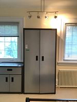 Front view of closed Gladiator cabinet next to small cabinet