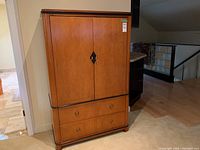 Full frontal view of closed cabinet dresser showing exterior finish and hardware.