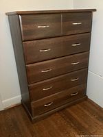 Front view of highboy dresser showing all five drawers and metal handles