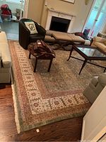 Overhead view of entire rug in living room showing overall design, size and border pattern