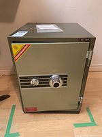 Front view of closed safe showing combination dial, key lock, USCAN logo and UC-159 model label