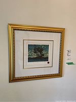 Framed Art Print hung on a wall showing the full framed artwork and gold frame.