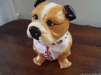 Front view of the ceramic dog cookie jar showing the dog's face and scarf with British flag motifs.