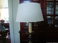 Full view of floor lamp showing the white waffle pattern shade and top of the lamp base
