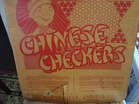 Original cardboard packaging for Chinese Checkers by Somerville Limited, featuring vintage graphic design and text, showing wear and tear.