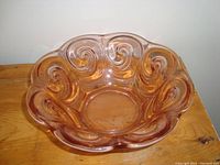 Top view of the pink depression glass bowl showing scalloped edges and swirl design.