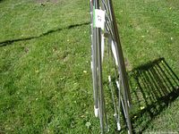 Folded clothes dryer rack showing metal frame and plastic joint covers.