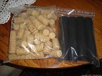 Plastic bags filled with natural wine corks and black shrink wraps
