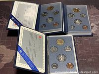 All three Canadian specimen coin sets laid out showing wallets and certificate inserts