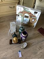 Photo showing the full set of decorative items including the miniature building, vases, brass sculpture, and small items on floor