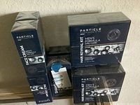 Photo showing 4 boxes of Particle Face Cream and 2 boxes of Shampoo along with 3 Hair Revival Kits in unopened packaging.