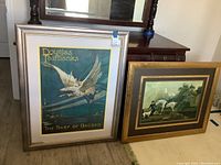 Set of two framed artworks, one being a vintage-style movie poster and the other a horse painting.