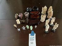 Overview of collection showing all figurines and stands arranged on dark surface