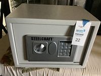 Front view of Steelcraft safe with keypad and turn handle, showing overall condition and scratches.
