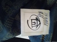 Close-up image showing the Sears Home label with handwritten code on the blue tablecloth fabric.