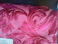 Close-up view showing the raised floral damask pattern with dusky pink shades.