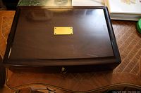 Closed view of wooden storage case with brass nameplate