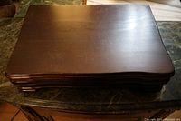 Wooden chest closed, dark wood with curved edges