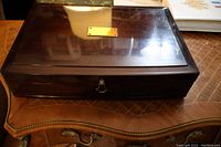Closed mahogany presentation box with brass nameplate on top