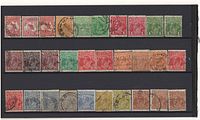 Photo showing an assortment of approximately 15 vintage Australian postage stamps. Designs include kangaroo, monarch portraits, and postmark cancellations in various colors.