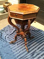 Front view of octagonal top and carved pedestal base