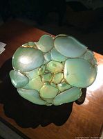 Overhead photo of the bowl showing the sea green colored shell-like segments inside the bowl resembling water or sea glass.