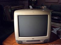 Front view of vintage Apple iMac showing CRT screen, built-in speakers, and front panel features