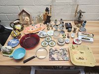Full overview of assorted decorative and household items arranged on wooden table
