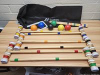 Full set laid out on wooden table with bag in background