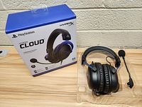 Front and side view of HyperX Cloud gaming headphones with packaging box showing PlayStation branding and product image.