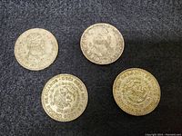 Four silver Mexican coins arranged flat showing obverse and reverse sides with worn details and some tarnishing.