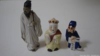 Photo showing the three porcelain figurines side-by-side for size and detail comparison