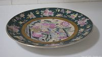 Front angle view of the large floral plate showing overall design and shape.