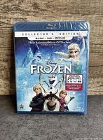 Front cover of Disney Frozen Collector's Edition Blu-Ray DVD with main characters Elsa, Anna, Olaf, Kristoff, Sven and seal wrap visible