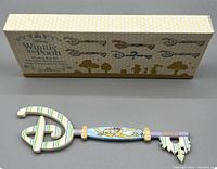 Disney Winnie the Pooh Rabbit Easter series decorative key with original box. Key features rabbit character and pastel striped design; box is beige with silhouettes of Winnie the Pooh characters and keys.