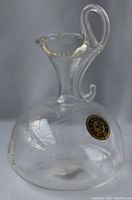 Full view of clear glass pitcher showing shape and handle