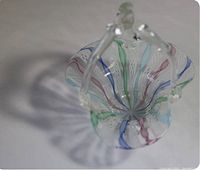 Top-down view showing the colorful swirled interior and petal-shaped rim of the Murano glass basket