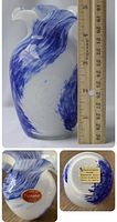 Close-up of vase with ruler showing approximately 7 inch height and the swirling blue over white design.