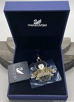 Swarovski kimono doll charm inside a blue Swarovski box with tag