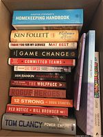 Top view of box containing assorted books stacked vertically and horizontally