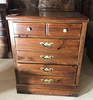 Front view of Ethan Allen wooden dresser showing 2 small top drawers with round wooden knobs and 2 large bottom drawers with brass handles. Some wear visible on base.