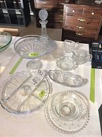 Full glassware set shown on a table with all items visible including decanter, compote, pickle tray, cream and sugar, small dishes.