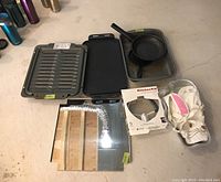 Full view of the pans, trays, KitchenAid attachment in box, and the Wilton Winnie cake pan.