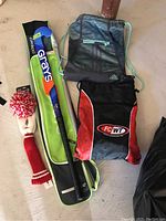 Top view showing the field hockey stick in its carrying bag, two sports bags, and a knit golf club head cover